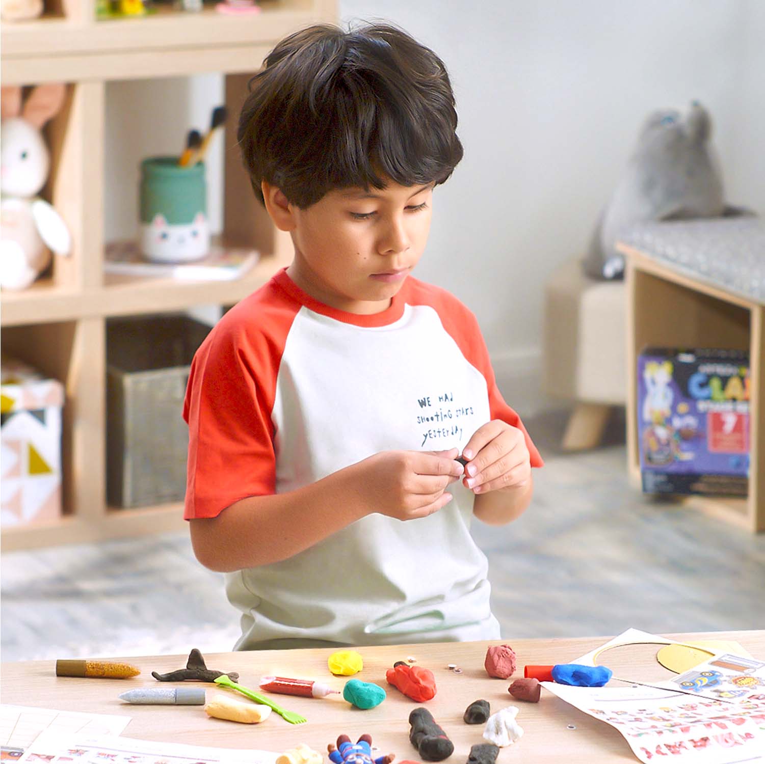 Boy playing with Kids Clay Stage Set, Superheroes